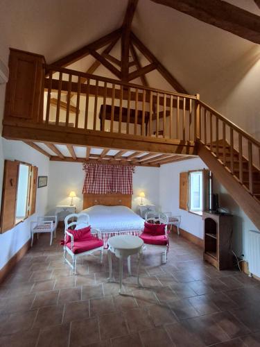 a large room with a bed and a staircase at Le Domaine des Buis in Albon