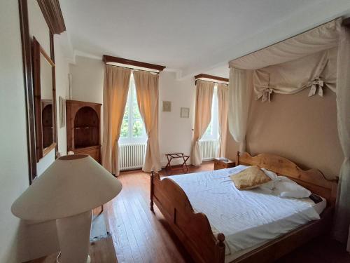 a bedroom with a bed and a lamp at Le Domaine des Buis in Albon