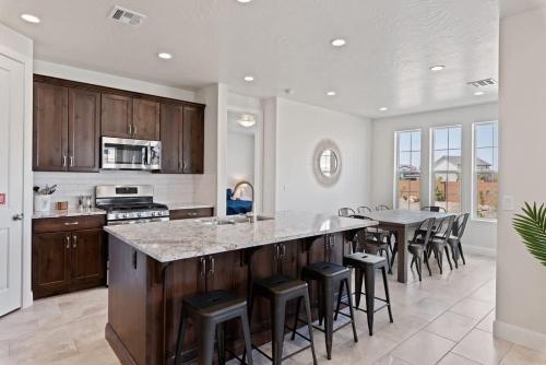 a kitchen with a large island with bar stools at Always the Weekend - Pool, Lazy River, Waterslide in Washington