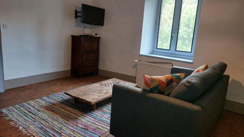 a living room with a couch and a coffee table at Les Gîtes Du Larderet in Le Larderet