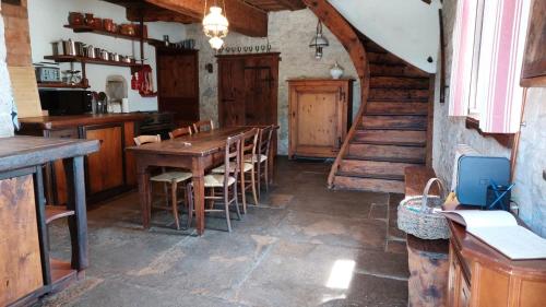 a kitchen with a wooden table and chairs at Les Gîtes Du Larderet in Le Larderet