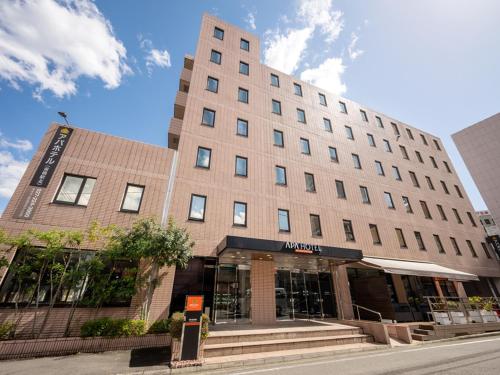 a building on a street in front of a building at APA Hotel Maebashieki-Kita in Maebashi