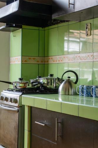 a kitchen with a stove and a tea kettle on the counter at Hotel Sierra Viva in Cajamarca