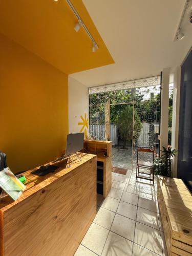 an office with a desk with a laptop on it at LumeHostel in João Pessoa