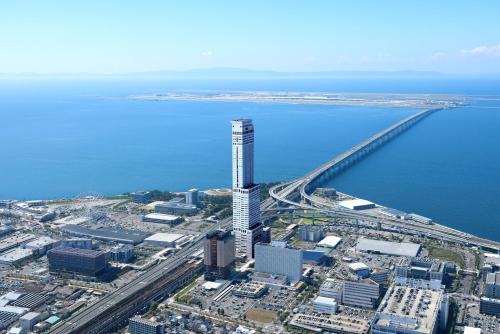 an aerial view of a city and the ocean at Odysis Suites Osaka Airport Hotel in Izumi-Sano