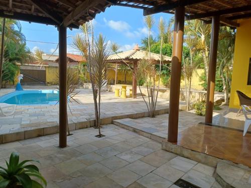 a patio with a pool and a gazebo at Cantinho da paz in Maragogi