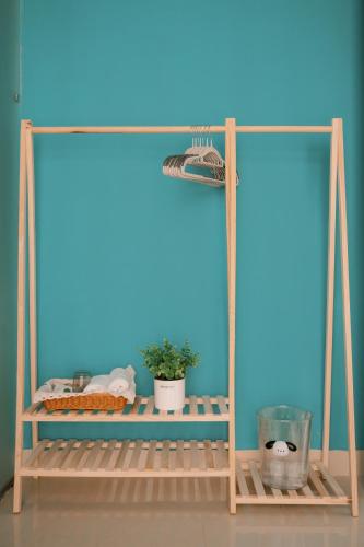 a shelf in a room with a blue wall at InHue Homestay in Thôn Trường Giang