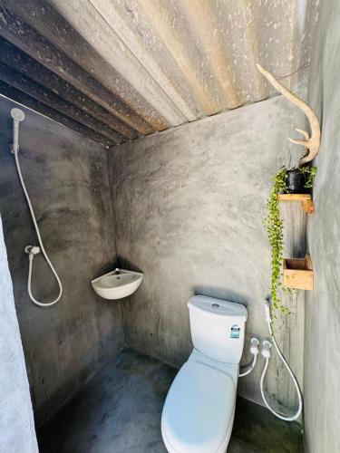 a bathroom with a toilet and a sink at Leopardbay Cabanas Arugambay in Arugam Bay