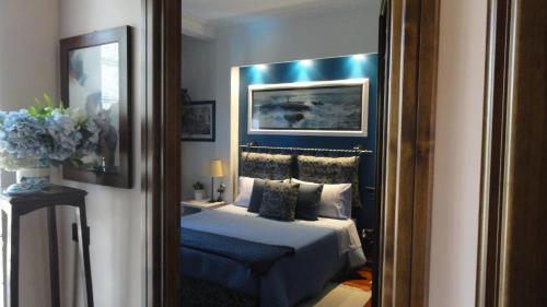 a bedroom with a bed and a mirror at B&B Le Lanterne in Casal Palocco