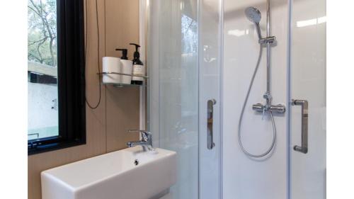 a bathroom with a sink and a shower at Forest Hill Farm by Tiny Away in Herbert