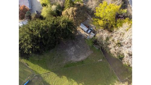 an aerial view of a park with trees and a bench at Forest Hill Farm by Tiny Away in Herbert