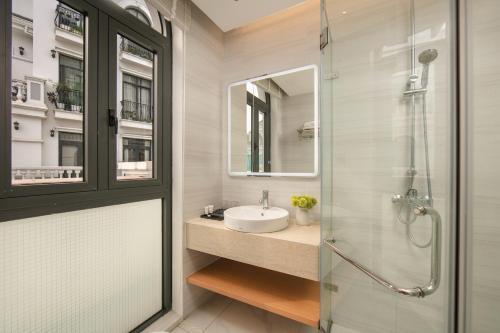 a bathroom with a sink and a shower at PCA HOTEL 1 - Vinhomes Ocean Park in Gia Lâm Pho
