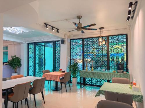 a restaurant with tables and chairs and a stained glass window at Apollo Vientiane Hotel in Vientiane