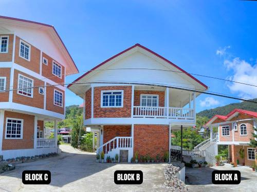 a large brick house with two stories at Kundasang Guesthouse in Kundasang