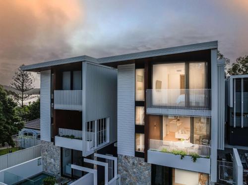 a rendering of an apartment building with balconies at Urbanstayz - Lakehouse No 2- Lakefront Luxury Escape Villa - Pet Friendly in Cabarita Beach