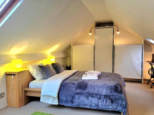 a bedroom with a large bed in a attic at Cosy flat, central location in Brussels