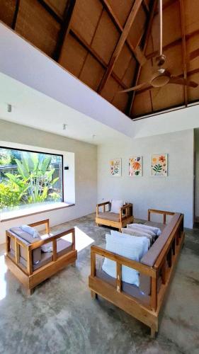 two beds in a room with a large window at Julita Boutique Villas in Burgos
