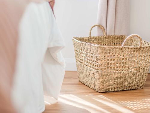 a basket sitting on a wooden floor next to a window at Upper Lvl Boyd-3 Bedroom Sunny Coastal in Tweed Heads