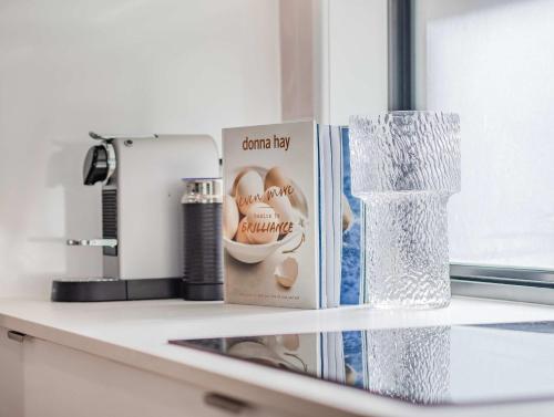a counter with a box and a vase on it at Upper Lvl Boyd-3 Bedroom Sunny Coastal in Tweed Heads