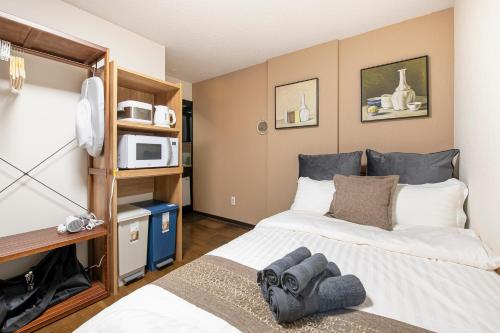 Postel nebo postele na pokoji v ubytování Livecore -Apartment hotel-