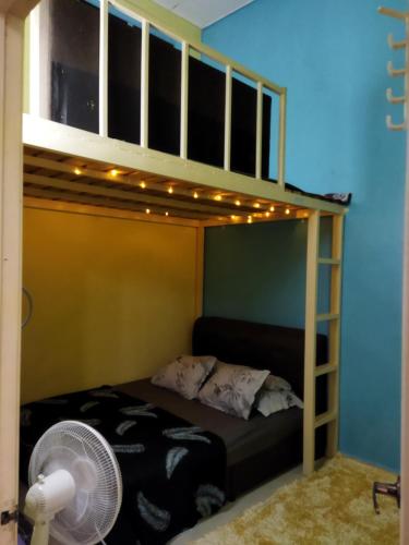 a bunk bed with a fan and lights on it at Homestay 4H Perlis in Kangar