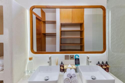 a bathroom with two sinks and a mirror at Villa Louna - 1BR Private Villa in Canggu in Kerobokan