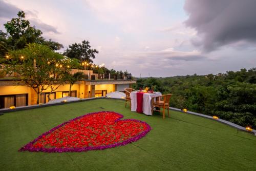 a room with a table with a heart made out of flowers at Abasan Hill Hotel and Spa in Nusa Penida