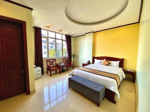a bedroom with a large bed and a large window at Gia Bao Hotel Bac Ninh in Hanoi