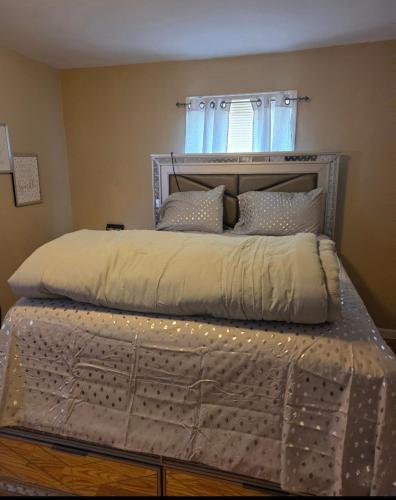 a bedroom with a bed with a metal frame at Comfortable & Relaxing Charming 3BR unit in Chicago