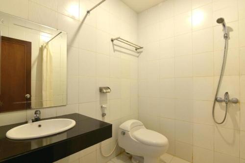 a bathroom with a toilet and a sink and a shower at Hotel Mekkah Banda Aceh in Banda Aceh