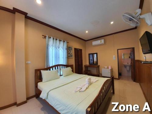 a bedroom with a bed with a towel on it at Ban Glai Kong in Chiang Khan