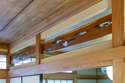 a wooden ceiling in a room with windows at Sankuya House in Kawaguchi