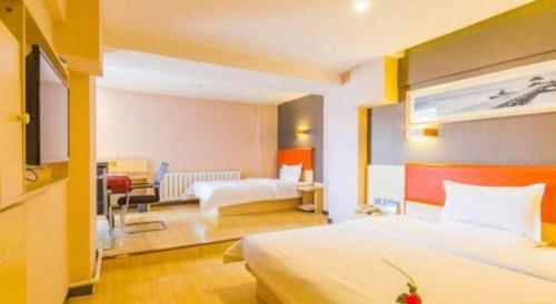a hotel room with a bed and a living room at 7 Days Premium Hohhot Hailiang Square in Hohhot