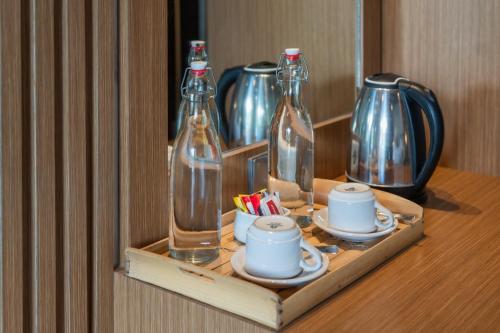 a shelf with bottles and cups on a table at Abasan Hill Hotel and Spa in Nusa Penida