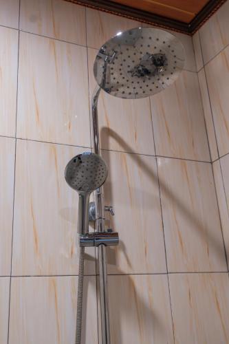 a shower with a shower head and a shower head at Abasan Hill Hotel and Spa in Nusa Penida