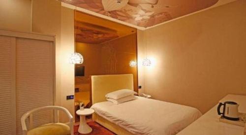 a bedroom with a bed and a ceiling at TO915101 STILL LOVE THEME HOTEL in Chengdu