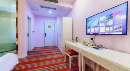 a room with a large monitor on a wall at TO915101 STILL LOVE THEME HOTEL in Chengdu