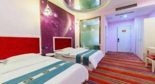 two beds in a room with purple and pink at TO915101 STILL LOVE THEME HOTEL in Chengdu