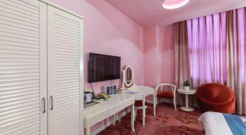 a bedroom with a pink room with a desk and a tv at TO915101 STILL LOVE THEME HOTEL in Chengdu