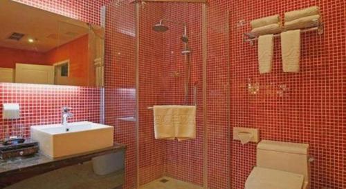 a red tiled bathroom with a sink and a toilet at TO915101 STILL LOVE THEME HOTEL in Chengdu