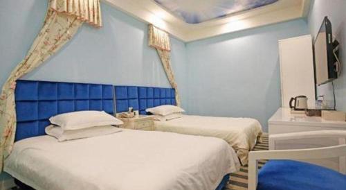 two beds in a room with blue walls at TO915101 STILL LOVE THEME HOTEL in Chengdu