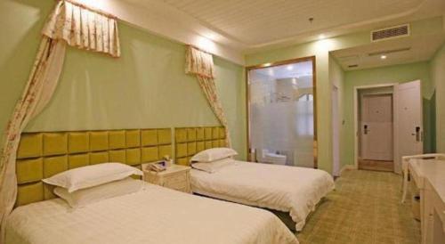 two beds in a room with green walls at TO915101 STILL LOVE THEME HOTEL in Chengdu