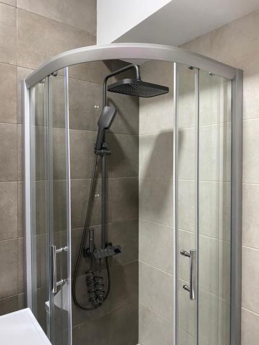 a shower with a glass door in a bathroom at Avlabari Inn - The coziest place in Tbilisi City