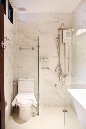 a bathroom with a toilet and a shower at Chinatown Night Market - Family Suite 2 BRs in Chiang Mai
