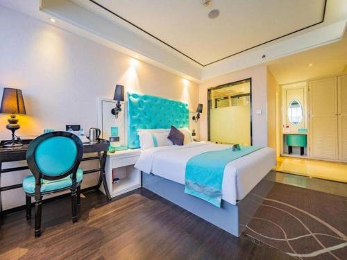 a bedroom with a bed and a desk and a chair at Xana Hotelle Xi'an 2nd Fengcheng Road Municipal Library Metro Station in Xi'an