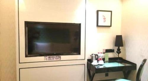 a living room with a large flat screen tv at Xana Lite Korla Shihua Avenue Longquehe in Korla