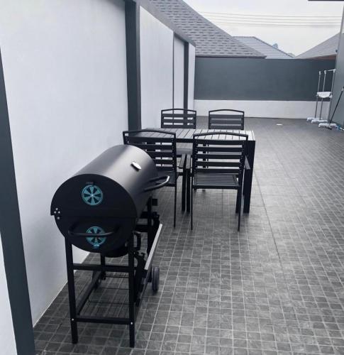 a room with a table and chairs and a grill at Vina Villa At Krabi in Ao Nang 