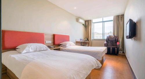 a hotel room with two beds and a television at Shanghai Jiejia hotel in Shanghai