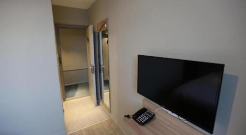 a flat screen tv on a wall in a room at Shanghai Jiejia hotel in Shanghai