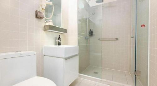 a bathroom with a shower and a toilet and a sink at Jinjiang Inn Select Tianjin Xiaobailou Metro Station in Tianjin